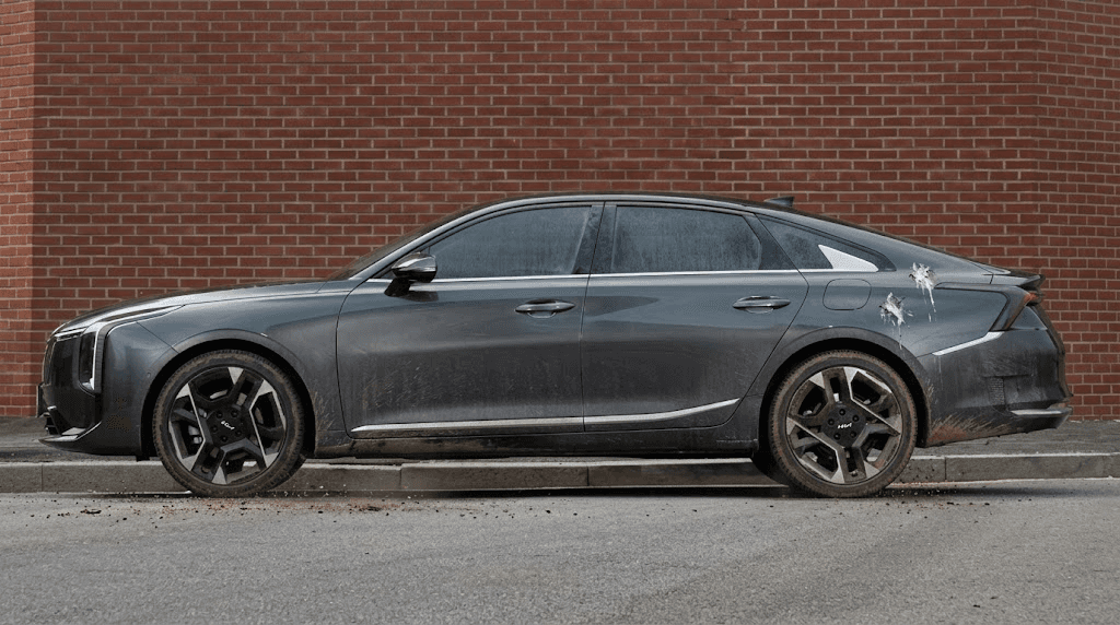 Grey Kia K4 saloon, side view, before
